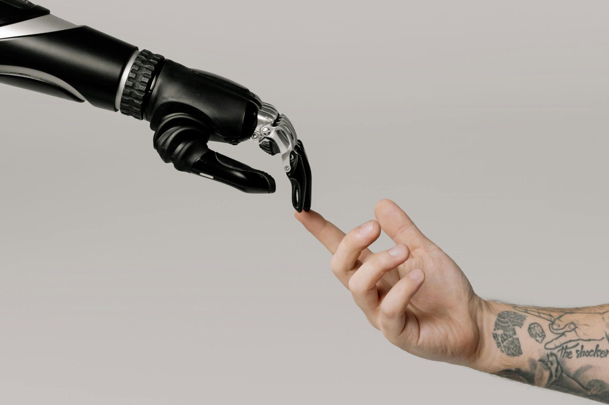 Human hand connecting with AI hand to show they understand each other.